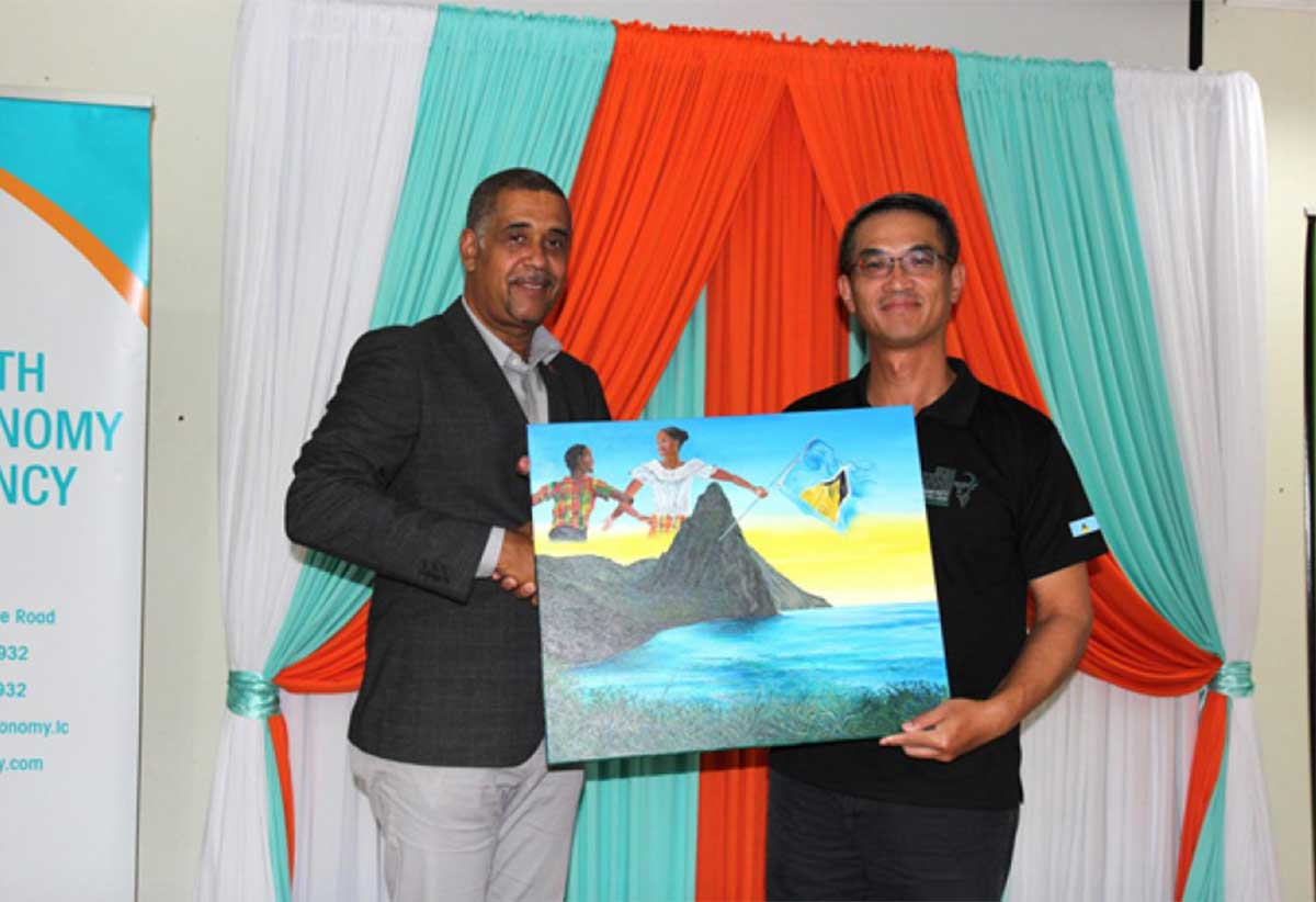 Mr. Thomas Leonce, Chairperson of the Youth Economy Agency, left, hands over a present to H.E. Peter Chia-Yen Chen, Taiwan’s Ambassador to Saint Lucia, during the certificate ceremony held at Union Orchid Gardens on Tuesday, November 5, 2024