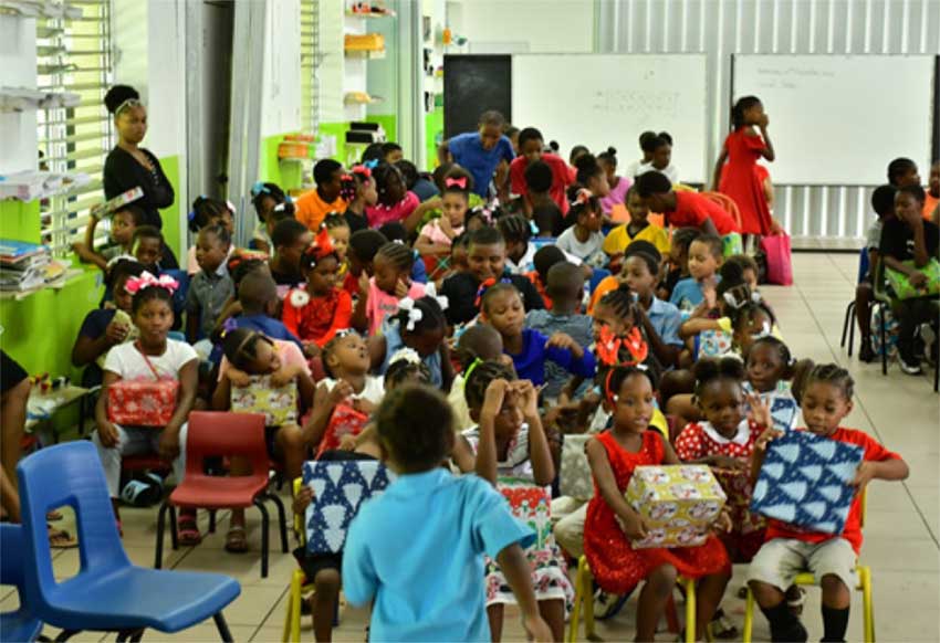 Children from the Bishop Charles Gachet RC School awaiting their Christmas gifts from Sandals