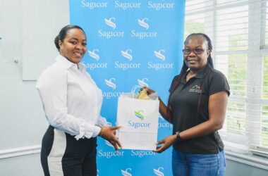 Sagicor Donates to St Lucia Cancer Society: From left; Kizzy Flood, Advisor, Sagicor Life (EC) Inc, St Lucia, presents Lista Louis of the St Lucia Cancer Society with a donation of funds raised during Pinktober 2024, Breast Cancer Awareness Month activities supported by Sagicor