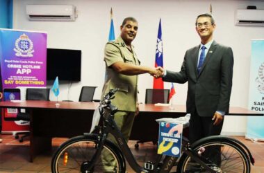 H.E. Peter Chia-Yen Chen, Taiwan’s Ambassador to Saint Lucia, right, hands over the electric-powered bicycle to Mr. Luke Defreitas, Assistant Commissioner of Police, left, at the closing ceremony held at Police Headquarters on Friday, November 29, 2024.