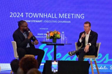 Executive Chairman Adam Stewart and Corporate Manager of Employee Experience Jamie Green address team members during a group-wide town hall meeting broadcast live across the nine countries where Sandals and Beaches Resorts operate