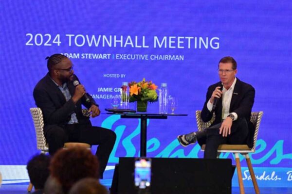 Executive Chairman Adam Stewart and Corporate Manager of Employee Experience Jamie Green address team members during a group-wide town hall meeting broadcast live across the nine countries where Sandals and Beaches Resorts operate