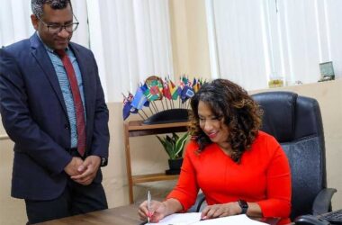 Dr Lisa Indar, CARPHA Ad Interim Executive Director signs the MOU between CARPHA and TEPHINET to strengthen public health and disease surveillance systems management in the Caribbean, while Dr Mark Sami, CARPHA Director Corporate Services looks on.