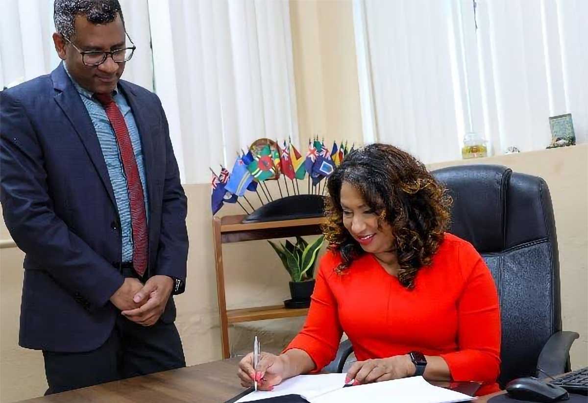 Dr Lisa Indar, CARPHA Ad Interim Executive Director signs the MOU between CARPHA and TEPHINET to strengthen public health and disease surveillance systems management in the Caribbean, while Dr Mark Sami, CARPHA Director Corporate Services looks on.