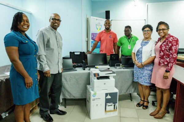 Minister Joachim Henry (2nd from left) and other officials at the handover ceremony…