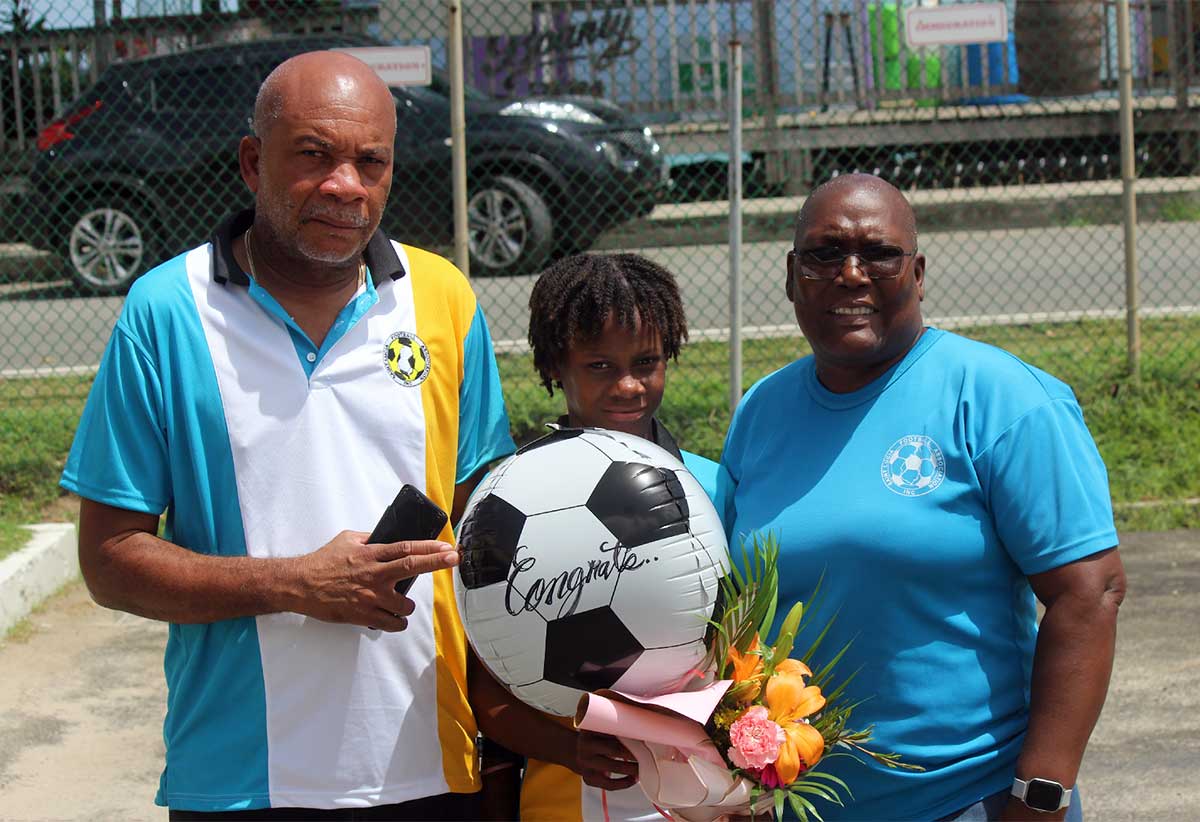 Kayla Polius (centre) is flanked by coach Felix St Rose (left) and manager Examine Philbert (right) both of whom congratulated her for her outstanding contribution to the game and her team.