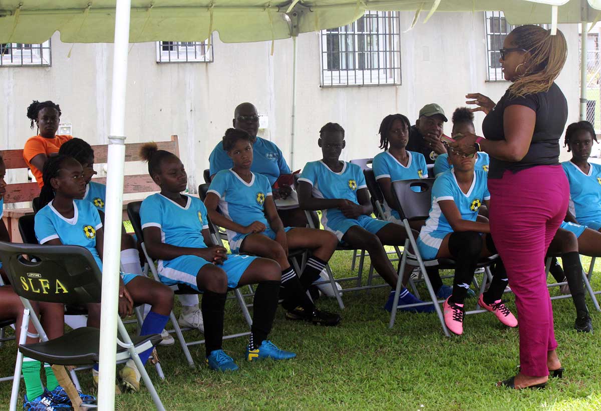 Natalie John with the National Under-14 Girls team including the team’s coach and manager at the SLFA Technical Venue in Mabouya, Dennery.