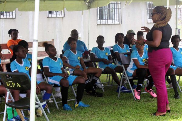 Natalie John with the National Under-14 Girls team including the team’s coach and manager at the SLFA Technical Venue in Mabouya, Dennery.