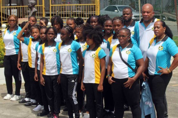 The team with managers and coaches at the Sir George F. L .Charles Airport Wednesday