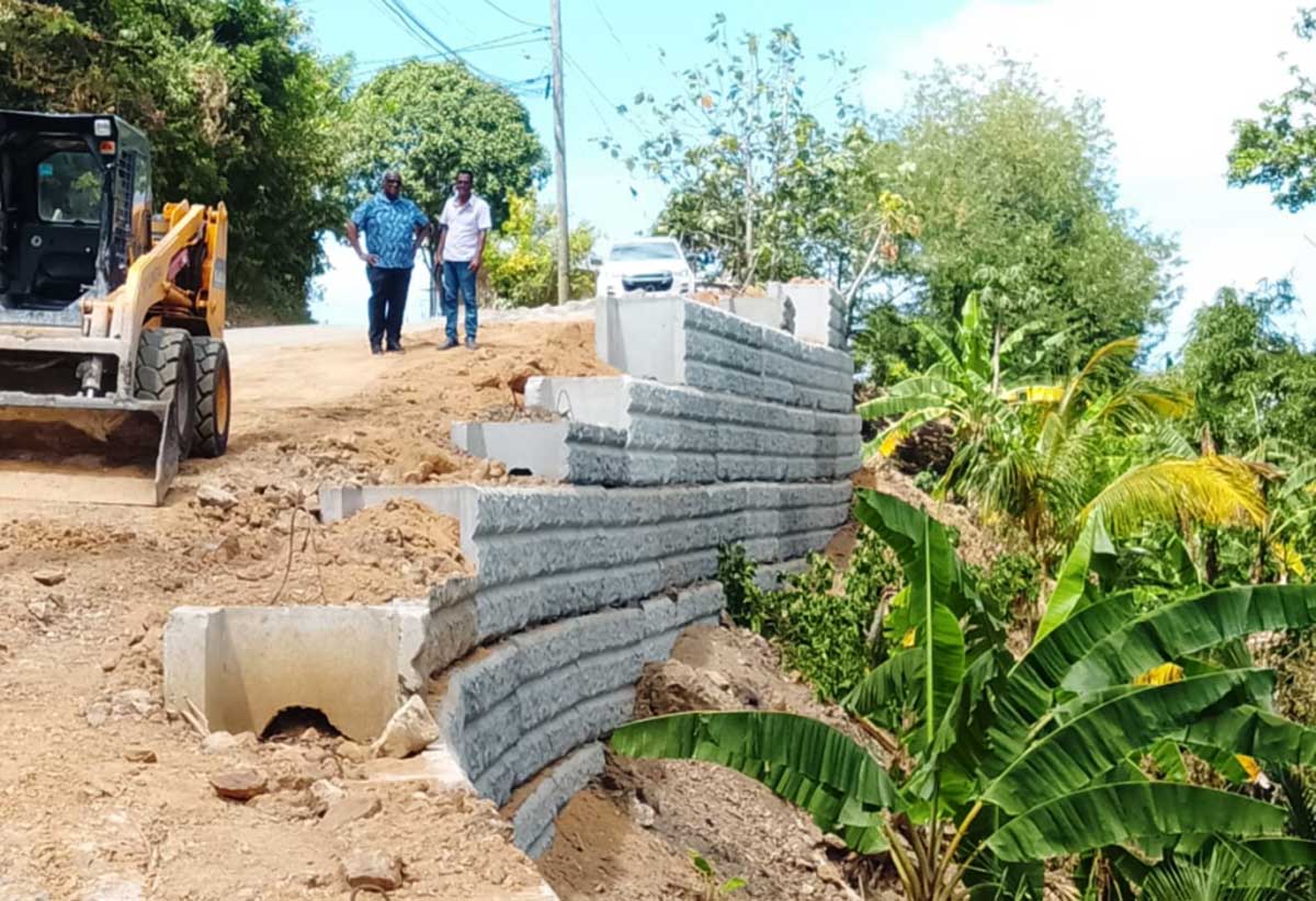 Minister King and Rayneau Gajadhar examining ongoing works on the Norbert/Vieux Serieux road bypass last Friday
