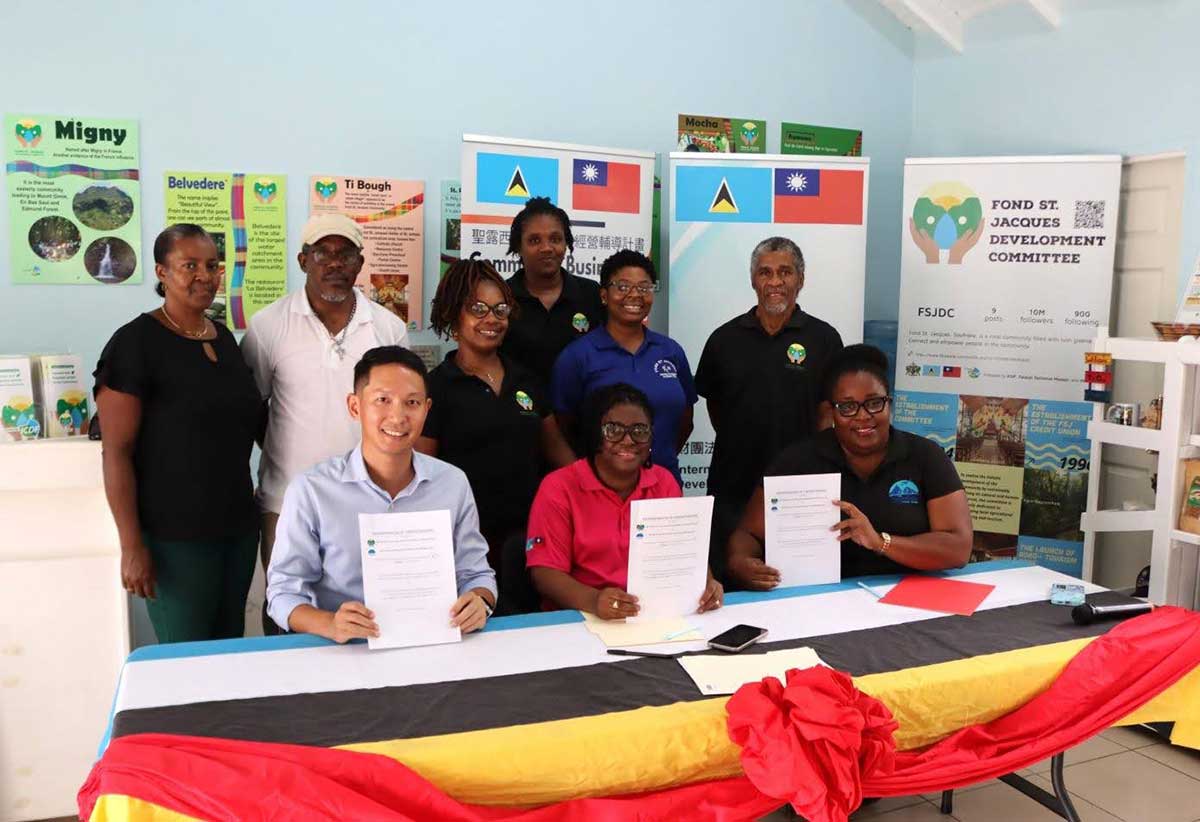 (from left to right, sitting) – Mr. Louis Tsou, Project Manager for the Community Business Revitalization Project (CBRP), Mrs. Sandra Prospere, President of Fond St. Jacques Development Committee, and Ms. Stephia Hippolyte, Manager for Product & Business Development for The Signature Travel Group Inc., with other members of the Fond St. Jacques Development Committee, at the MoU signing in Fond St. Jacques on Wednesday, October 8, 2025. 