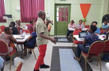 MC Gilroy “Ezi” Hall tutors participants on emceeing skills [Photo credit :CDF]