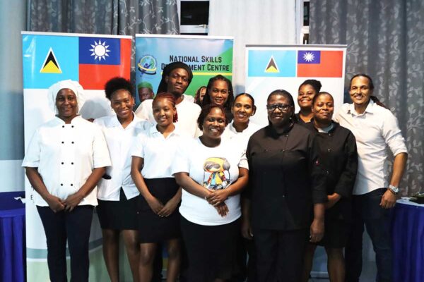 Chef Nicos Anthony, at far right, poses with the chefs from NSDC’s Vieux Fort centre for a group photo.