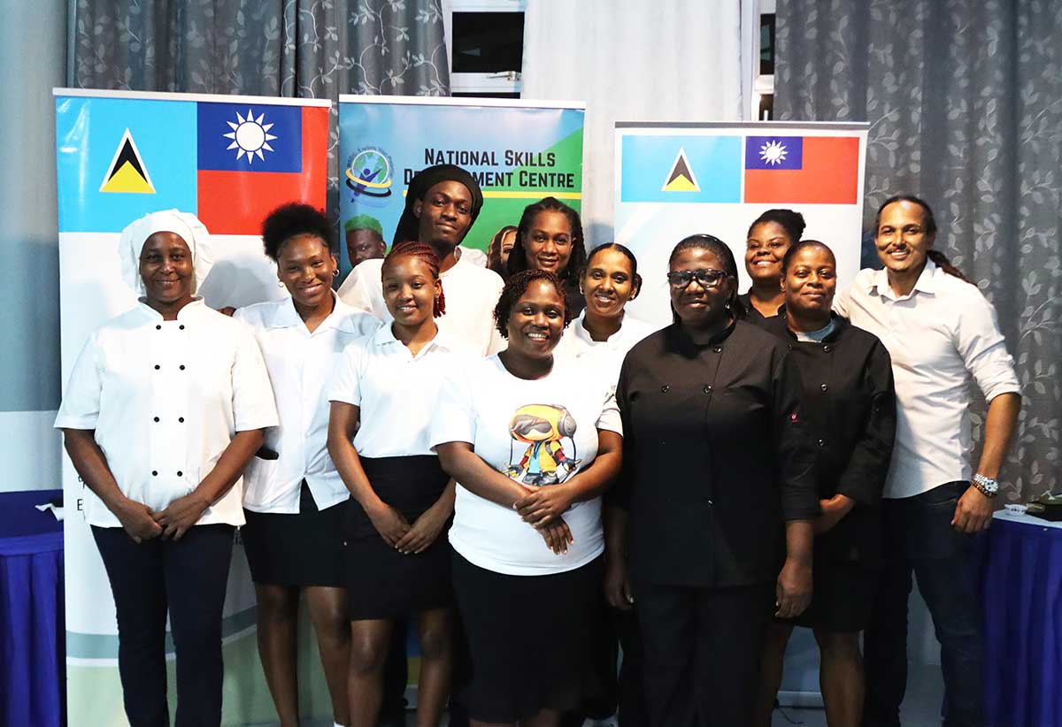 Chef Nicos Anthony, at far right, poses with the chefs from NSDC’s Vieux Fort centre for a group photo.