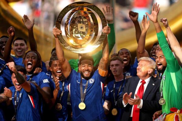 EAST RUTHERFORD, NEW JERSEY ‑ JULY 13: Reece James #24 of Chelsea FC lifts the FIFA Club World Cup trophy after their team's victory as U.S. President Donald Trump reacts following the FIFA Club World Cup 2025 Final match between Chelsea FC and Paris Saint‑Germain at MetLife Stadium on July 13, 2025 in East Rutherford, New Jersey. Photo by Carl Recine – FIFA