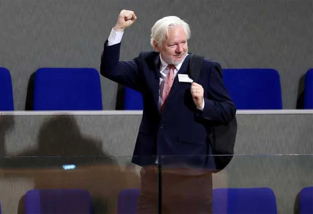 WikiLeaks founder Julian Assange raises his fist after a debate focused on his detention and conviction at the Council of Europe in Strasbourg, France, on October 2, 2024 [Frederick Florin/AFP]