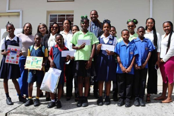Dr. Charmaine Hippolyte-Emmanuel, Permanent Secretary in the Ministry of Equity, Mrs. Selena Chang, Deputy Counselor at the Embassy of the Republic of China (Taiwan), with teachers and students from the top three performing schools at the awards ceremony.