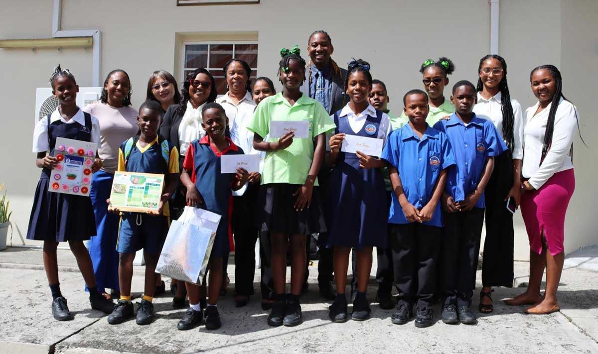 Dr. Charmaine Hippolyte-Emmanuel, Permanent Secretary in the Ministry of Equity, Mrs. Selena Chang, Deputy Counselor at the Embassy of the Republic of China (Taiwan), with teachers and students from the top three performing schools at the awards ceremony.