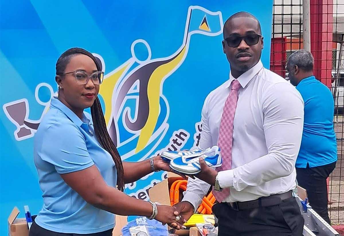 Sports Minister Casimir presents sporting equipment to SLAA officials [Photo credit: MYDS]