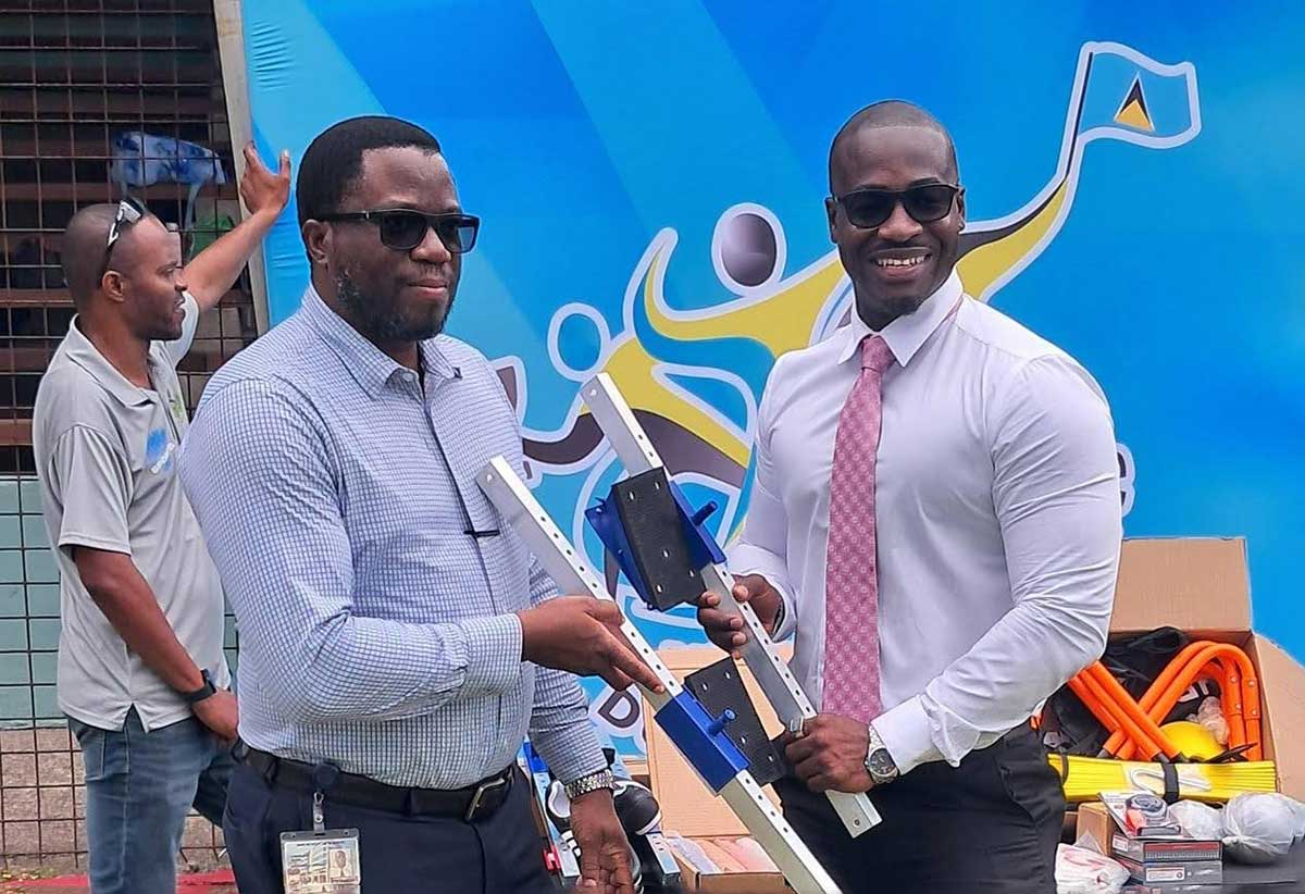 Sports Minister Casimir presents sporting equipment to SLAA officials [Photo credit: MYDS]