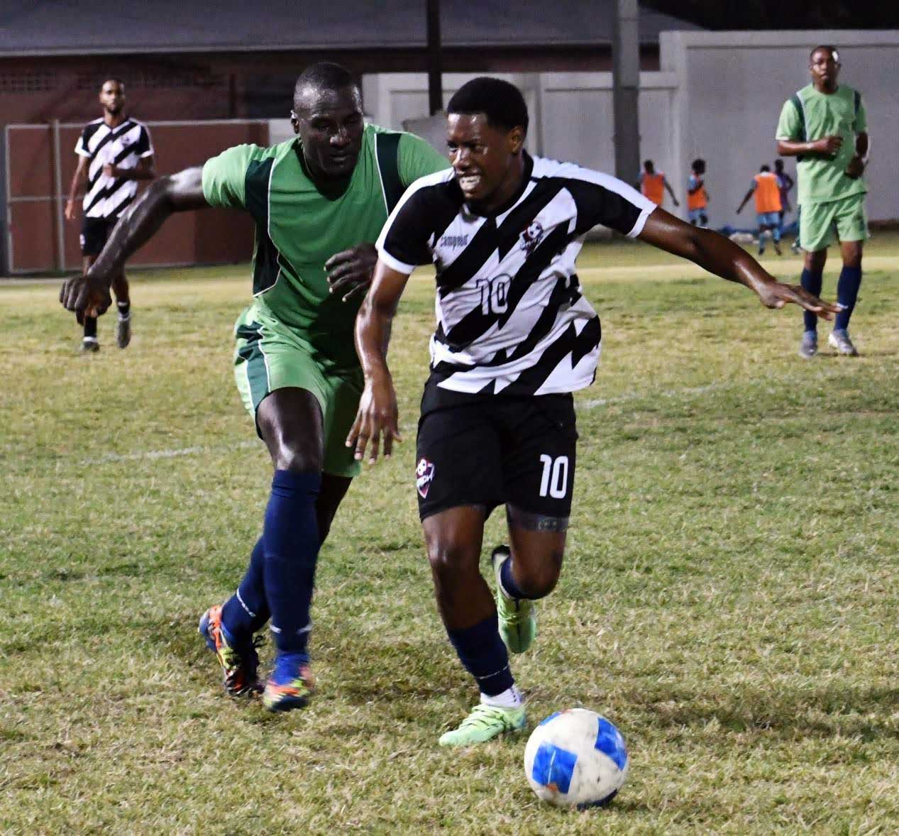 Monchy FC striker (black and white) on the attack versus Police (Photo credit: MYDS)