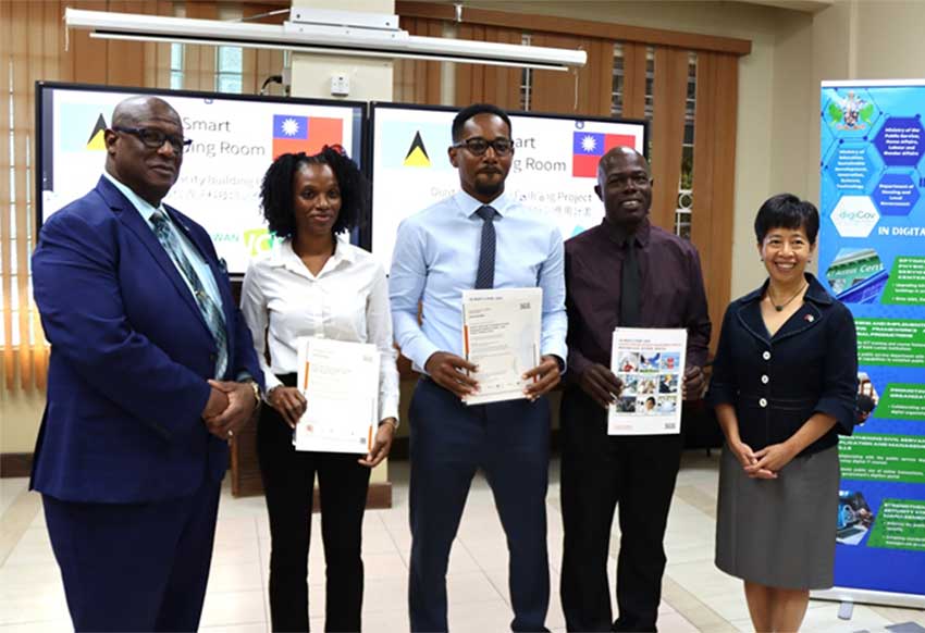 H.E. Nicole Su, Taiwan’s Ambassador to Saint Lucia, and Hon. Stephenson King, Senior Minister for the Ministry of Public Service, Transport, Information and Utilities Regulations, pose with the three participants in the ISO/IEC 27001 workshop (Credit: TTM)