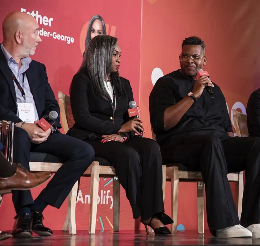 Senator The Hon. Jonathan Reid, Minister of Innovation, Industry, Science and Technology, Government of Barbados, engages fellow speakers Luis Marrero (Amazon Web Services) and Esther Callender-George (Guardian Holdings Limited) during the panel discussion ‘Scaling Digital Transformation in the AI Era’.