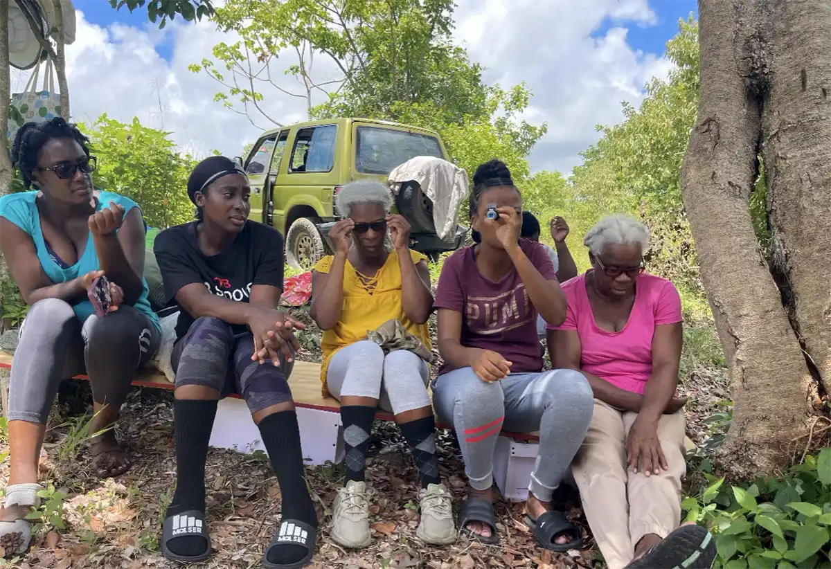 Honey Producers taking a rest after training and attending to their hives, Mon Repos, Saint Lucia. 