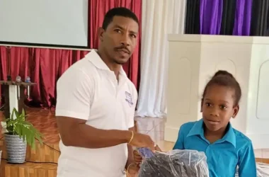 Former Professional and National Footballer Elijah Joseph presenting to a young recipient. [Photo Credit: Lastic Foundation]