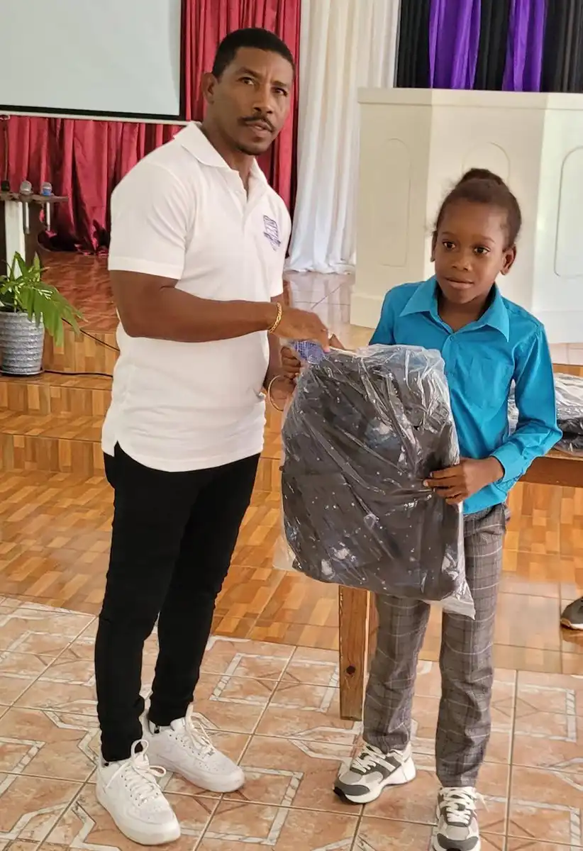 Former Professional and National Footballer Elijah Joseph presenting to a young recipient. [Photo Credit: Lastic Foundation]