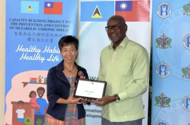 Ambassador Nicole Su hands over the tablet computers to Health Minister Hon. Moses Jn. Baptiste