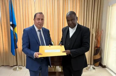 L-R: Ambassador H.E. Younes Dirhoussi (left) presents copies of his credentials to External Affairs Minister Alva Baptiste on April 9th, 2026 (Photo credit: Moroccan Embassy – File).