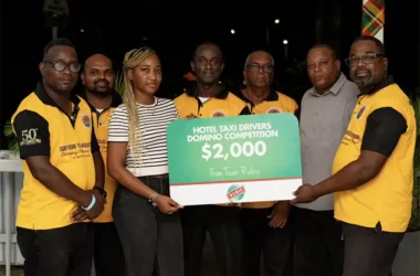 Tamika Celestin, Assistant Accounts Executive, RUBIS, presents cheque to members of the Hotel Taxi Association. (Photo – Contributed)